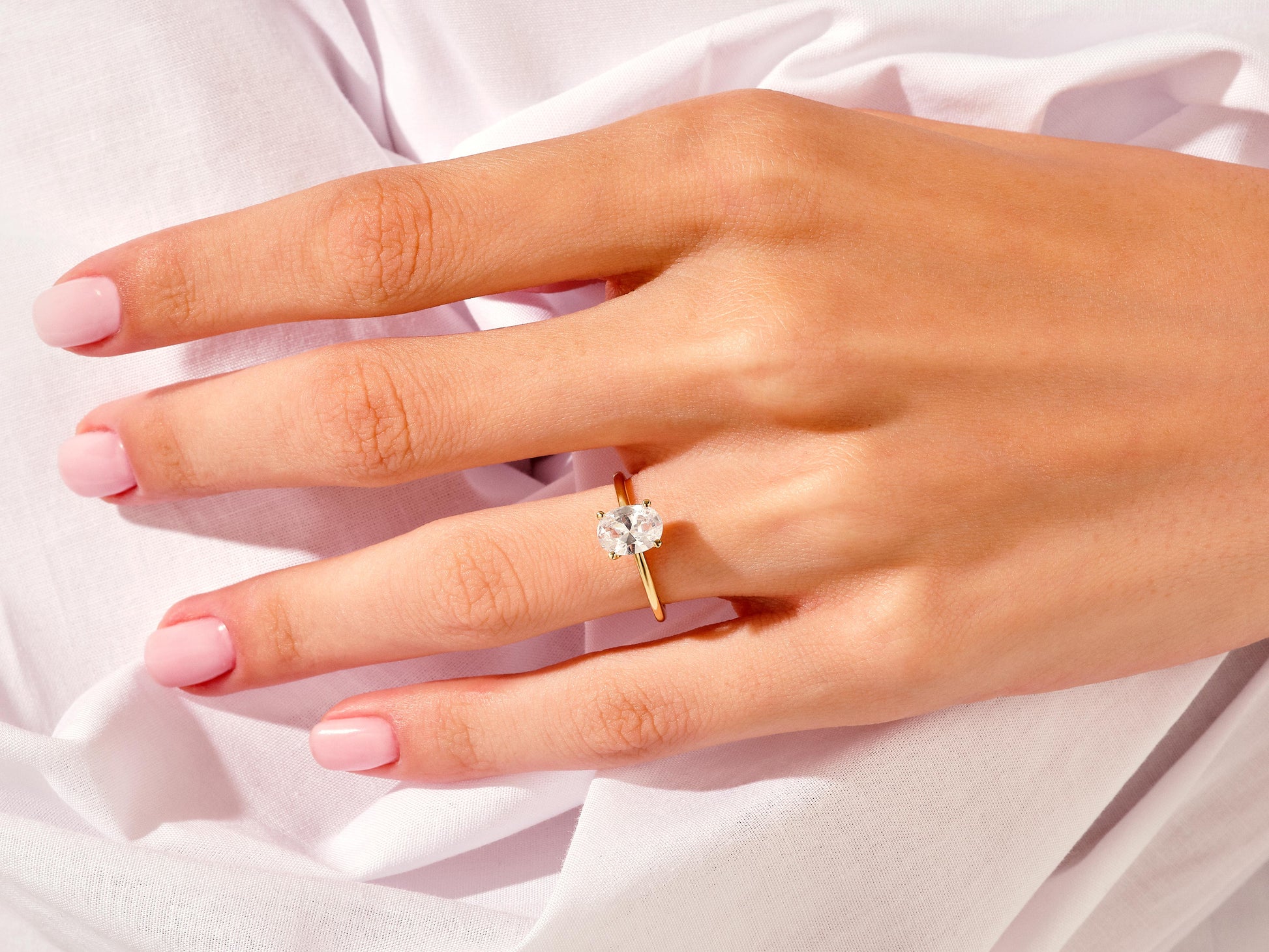 14k Gold, 18k Gold, Yellow, White, Rose, 4-Prong Oval Cut 1.5 carat Moissanite Engagement Ring on a Woman's Ring Finger